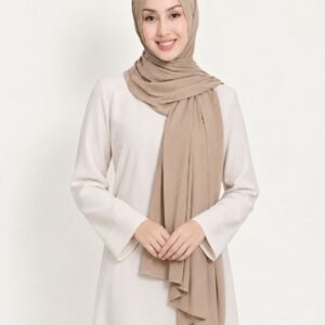 Woman with hands clasped wearing a beige liquid jersey shawl