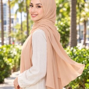 Woman on a palm-lined street in a peach liquid jersey drape
